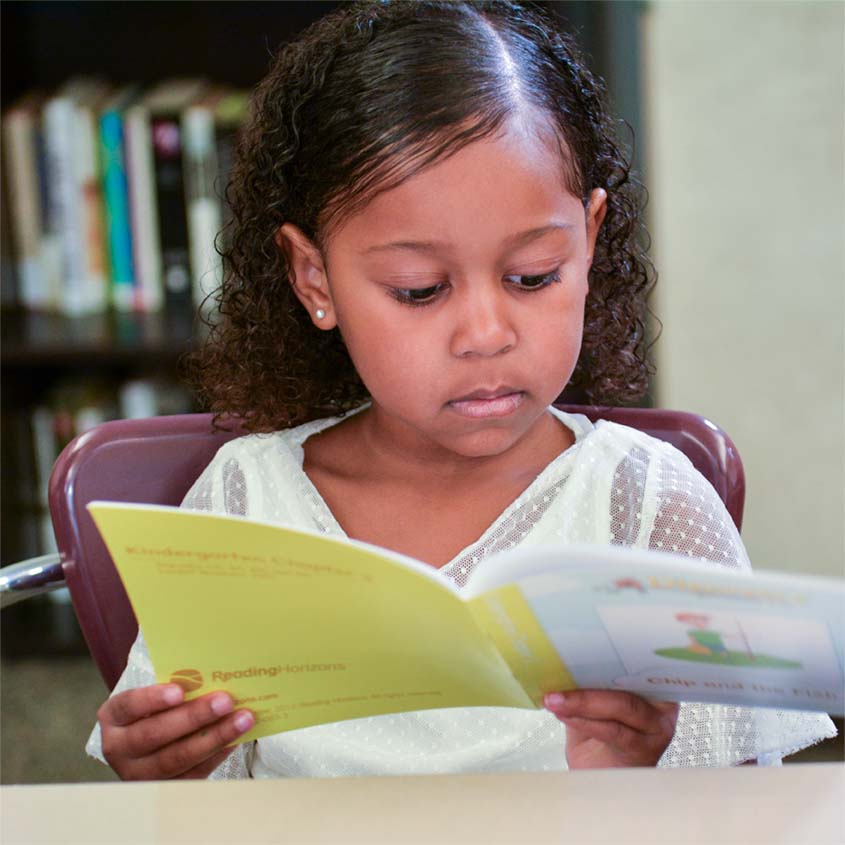 Young girl reading a Discovery